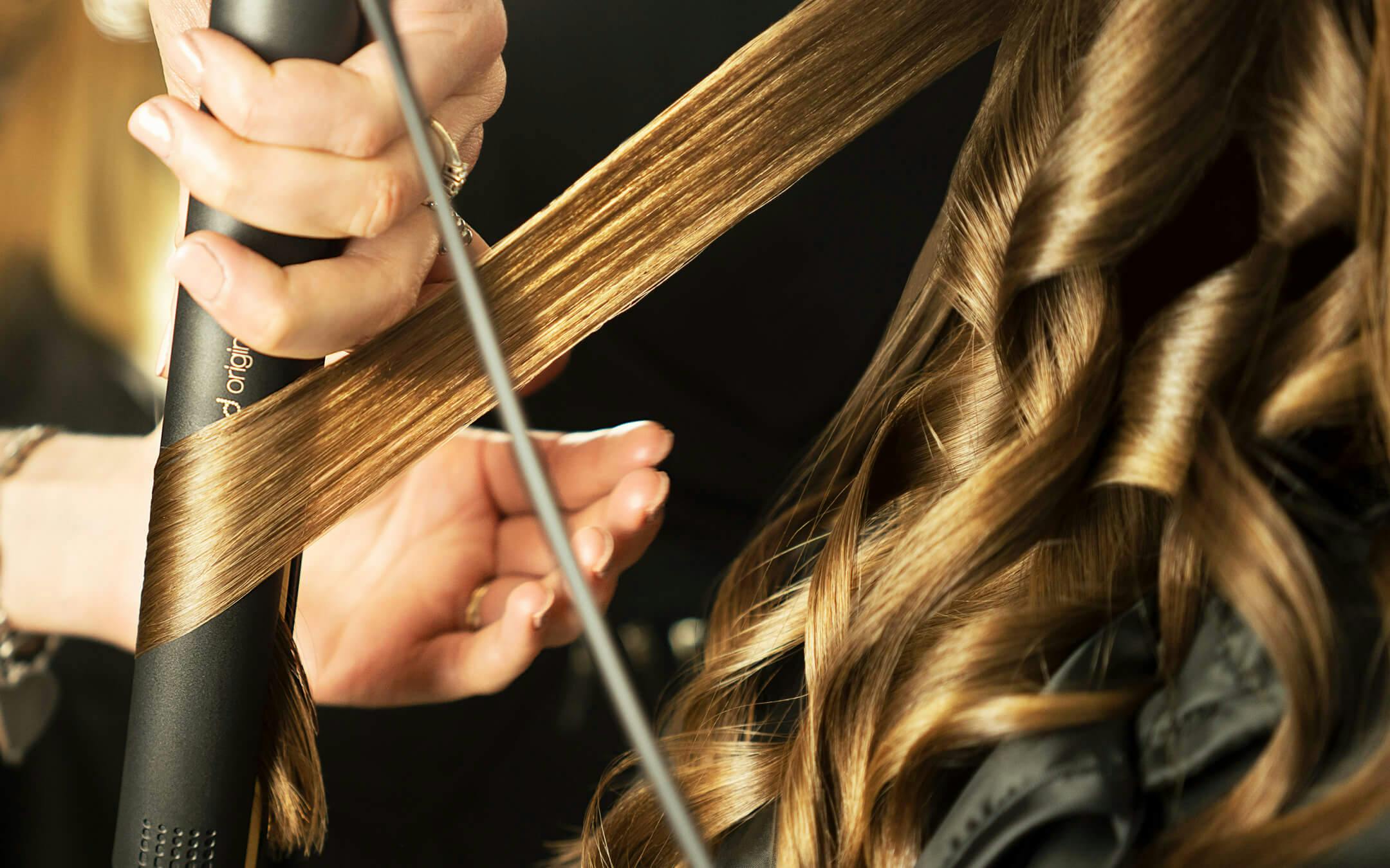 A woman has her hair professionally styled as a cover of the new "Free Your Style" campaign. Created by Dynamo for ghd Italy.